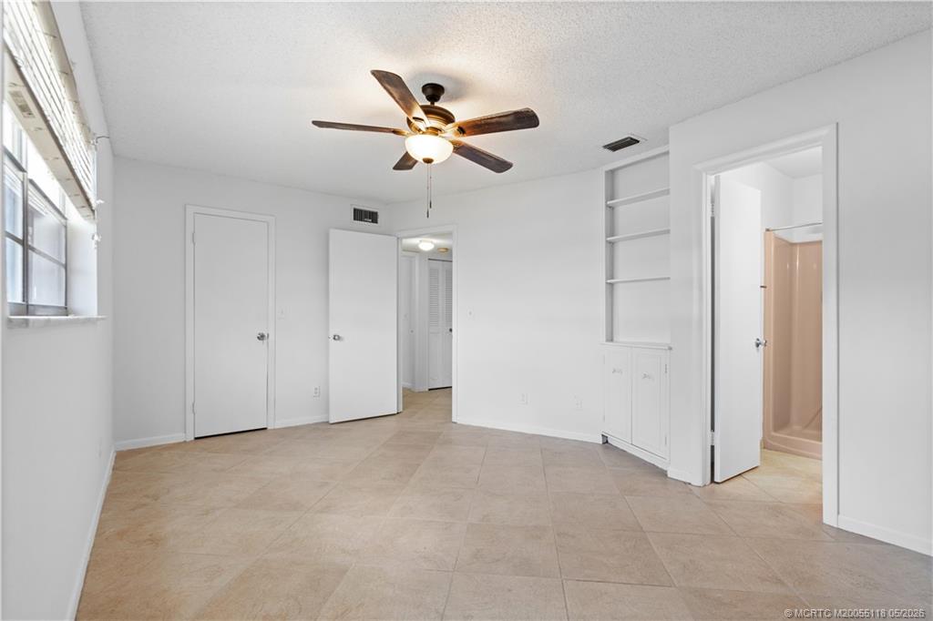2118 Southeast Edler Drive, Unit B Stuart, FL 34994 - Photo 15 of 20 an empty room with closet and windows