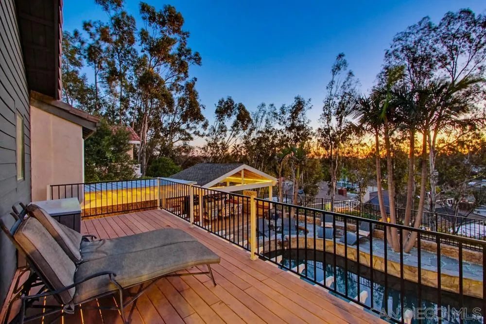 a view of a roof deck with wooden fence and floor