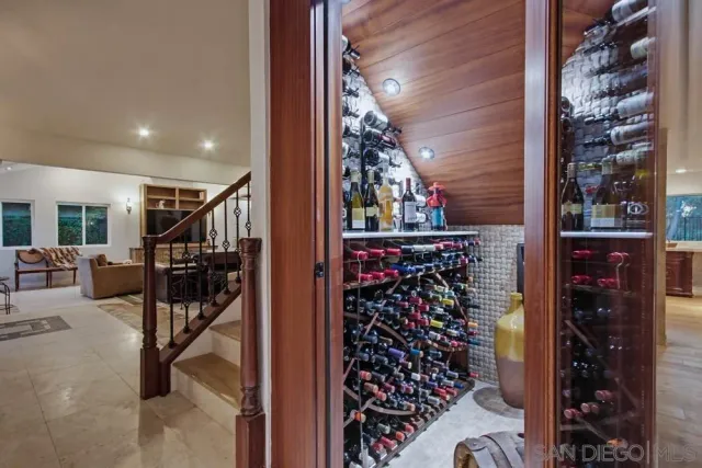 a living room with furniture a flat screen tv and a large window