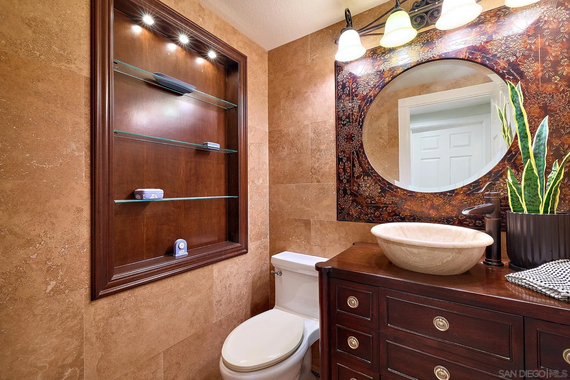 10616 Falcon Rim Point San Diego, CA 92131 - Photo 19 of 44 a bathroom with a toilet a sink and mirror