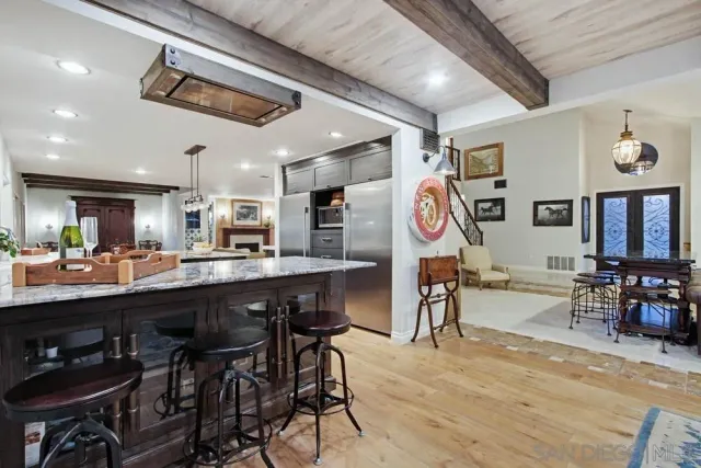 a kitchen with stainless steel appliances granite countertop a stove a sink dishwasher and a refrigerator