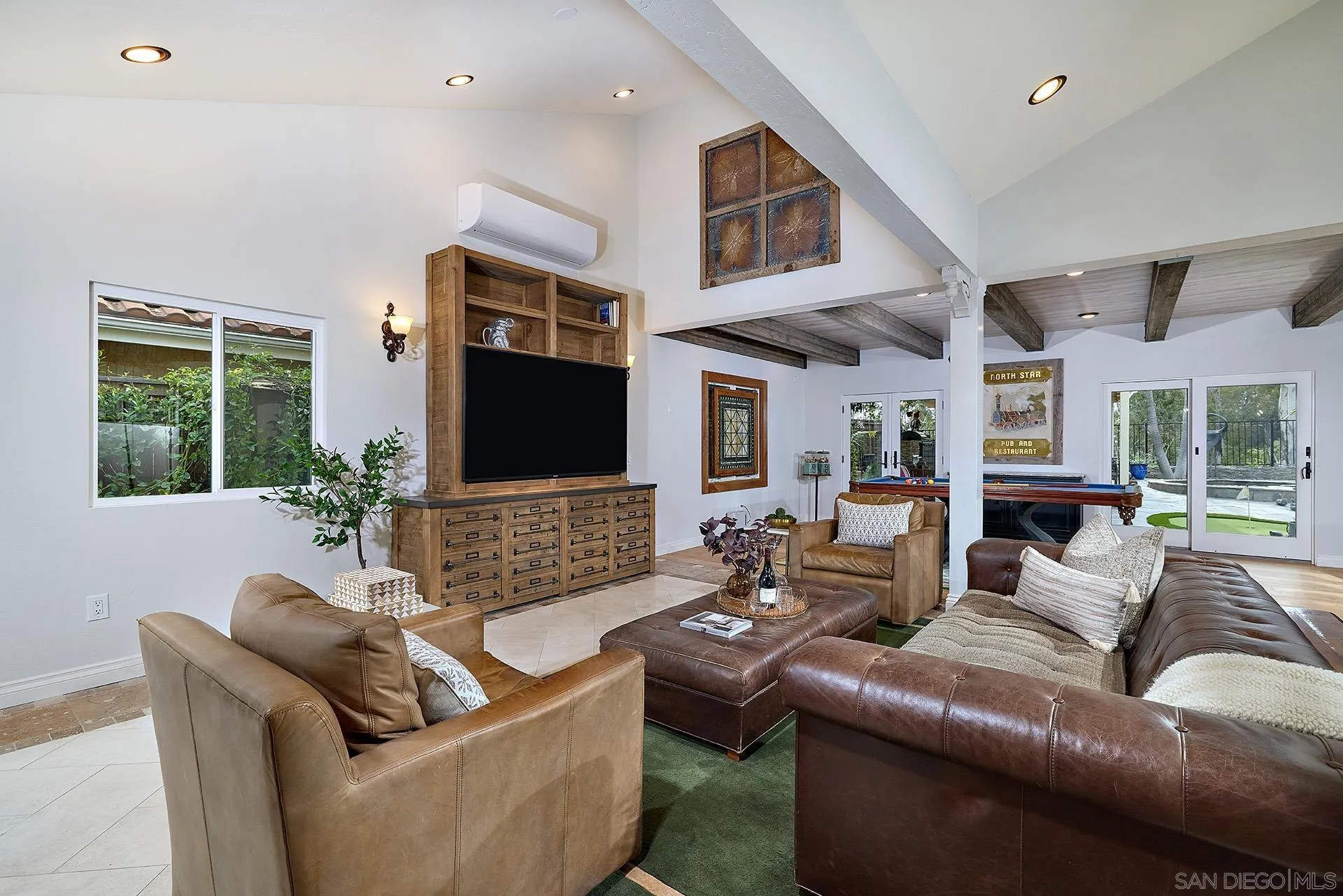 10616 Falcon Rim Point San Diego, CA 92131 - Photo 6 of 44 a living room with furniture and a flat screen tv