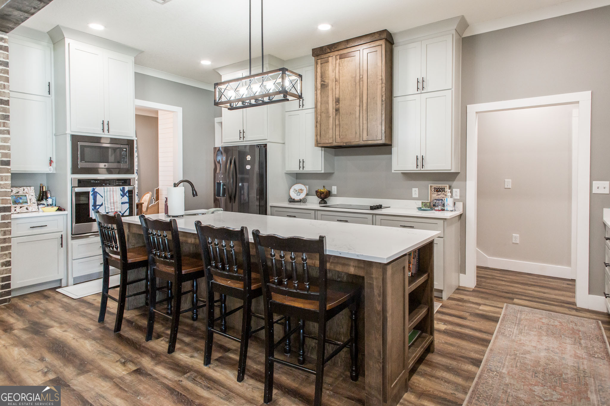 664 Saddle Circle Waycross, GA 31503 - Photo 16 of 39 a kitchen with stainless steel appliances granite countertop a table chairs and a refrigerator