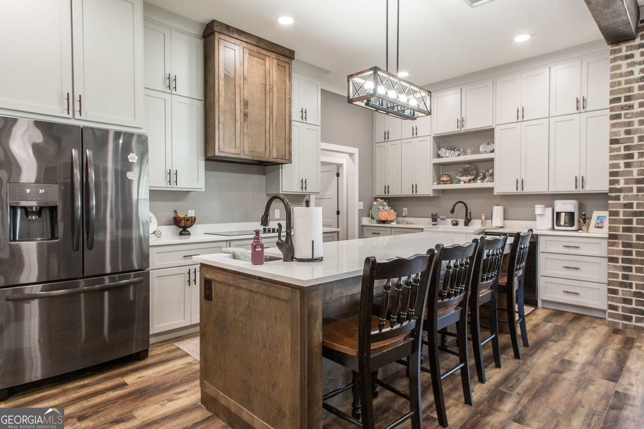 664 Saddle Circle Waycross, GA 31503 - Photo 17 of 39 a kitchen with refrigerator cabinets and wooden floor