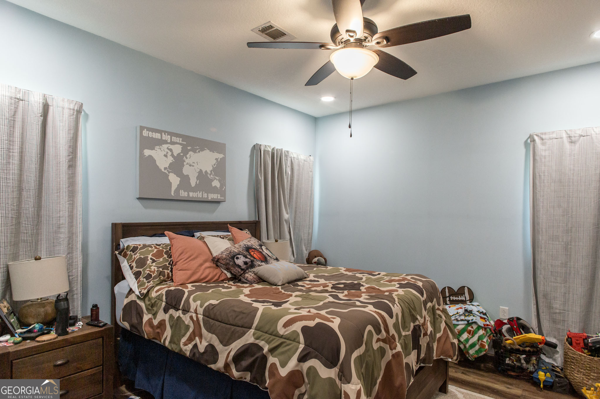 664 Saddle Circle Waycross, GA 31503 - Photo 25 of 39 a bedroom with a bed and a chandelier