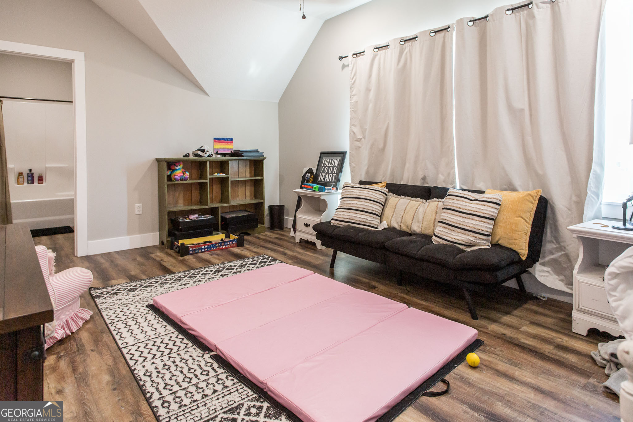664 Saddle Circle Waycross, GA 31503 - Photo 28 of 39 a living room with furniture a rug and a wooden floor