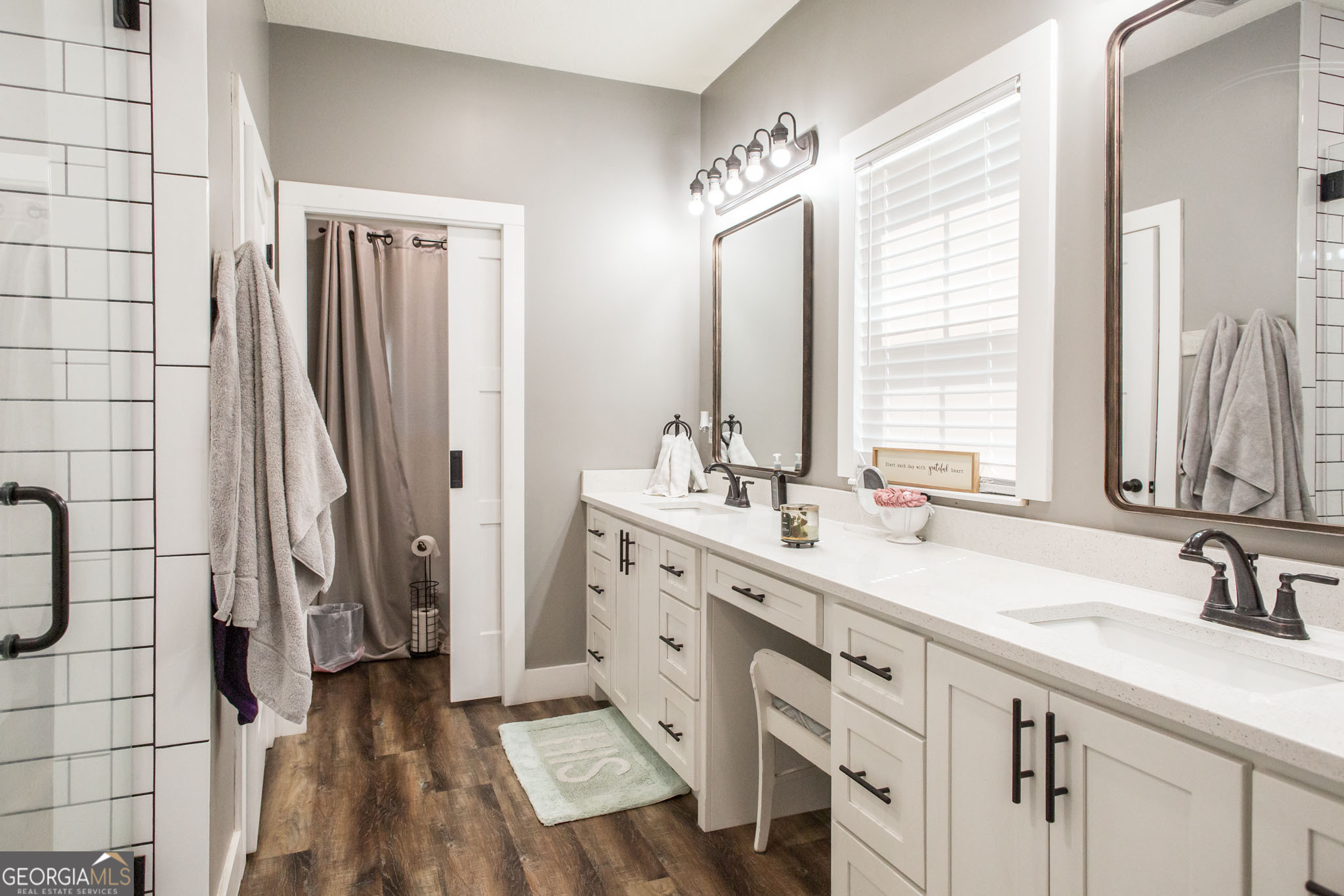 664 Saddle Circle Waycross, GA 31503 - Photo 35 of 39 a spacious bathroom with double vanity and a mirror