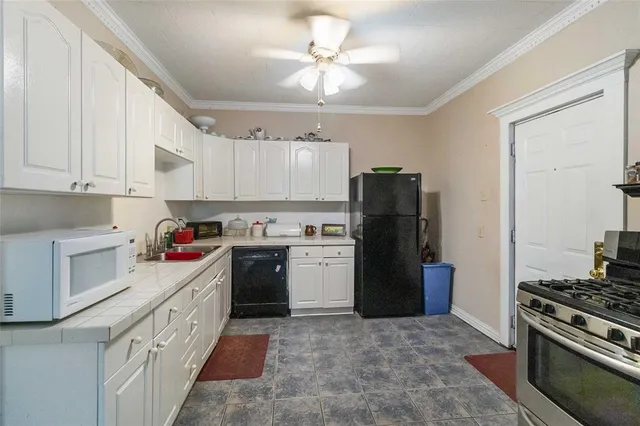 a kitchen with a stove a refrigerator and a sink
