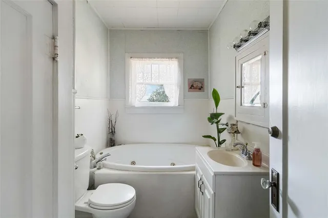 a bathroom with a sink a toilet and bathtub