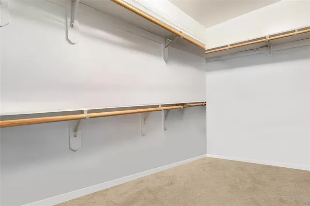 a bedroom with a bed and a flat tv screen on dresser