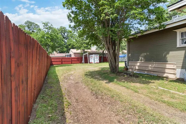 a view of a house with a yard and sitting area