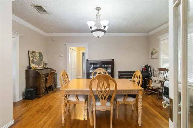 a view of a dining room with furniture and a chandelier