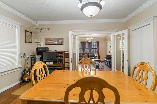 a dining hall with a dining table and chairs