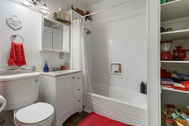 a bathroom with a toilet and a shower curtain