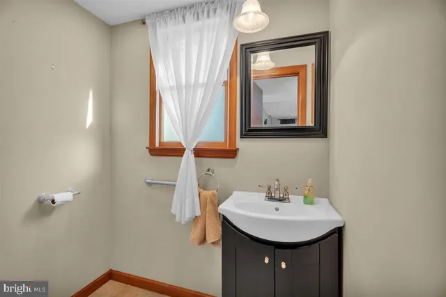 a bathroom with a sink a mirror and a window