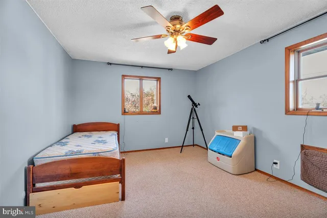 a bedroom with furniture and a window