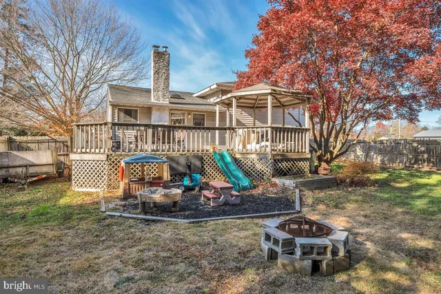 a view of a house with backyard water fountain and sitting area