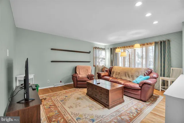 a living room with furniture rug and a large window