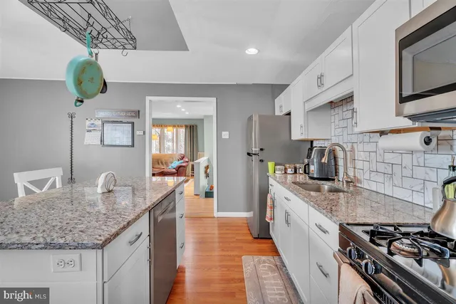 a kitchen with sink stove and cabinets