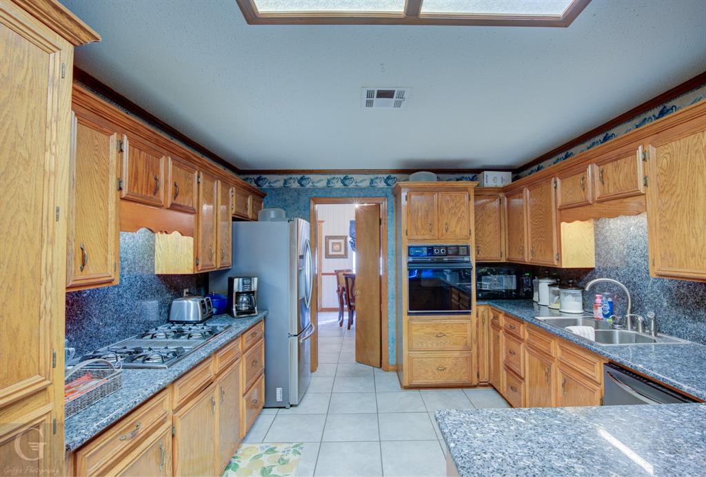 111 White Road Frierson, LA 71027 - Photo 11 of 18 a large kitchen with stainless steel appliances granite countertop a sink and cabinets