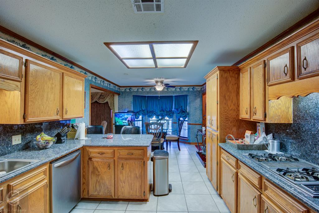 111 White Road Frierson, LA 71027 - Photo 12 of 18 a kitchen with stainless steel appliances kitchen island granite countertop a sink stove and cabinets