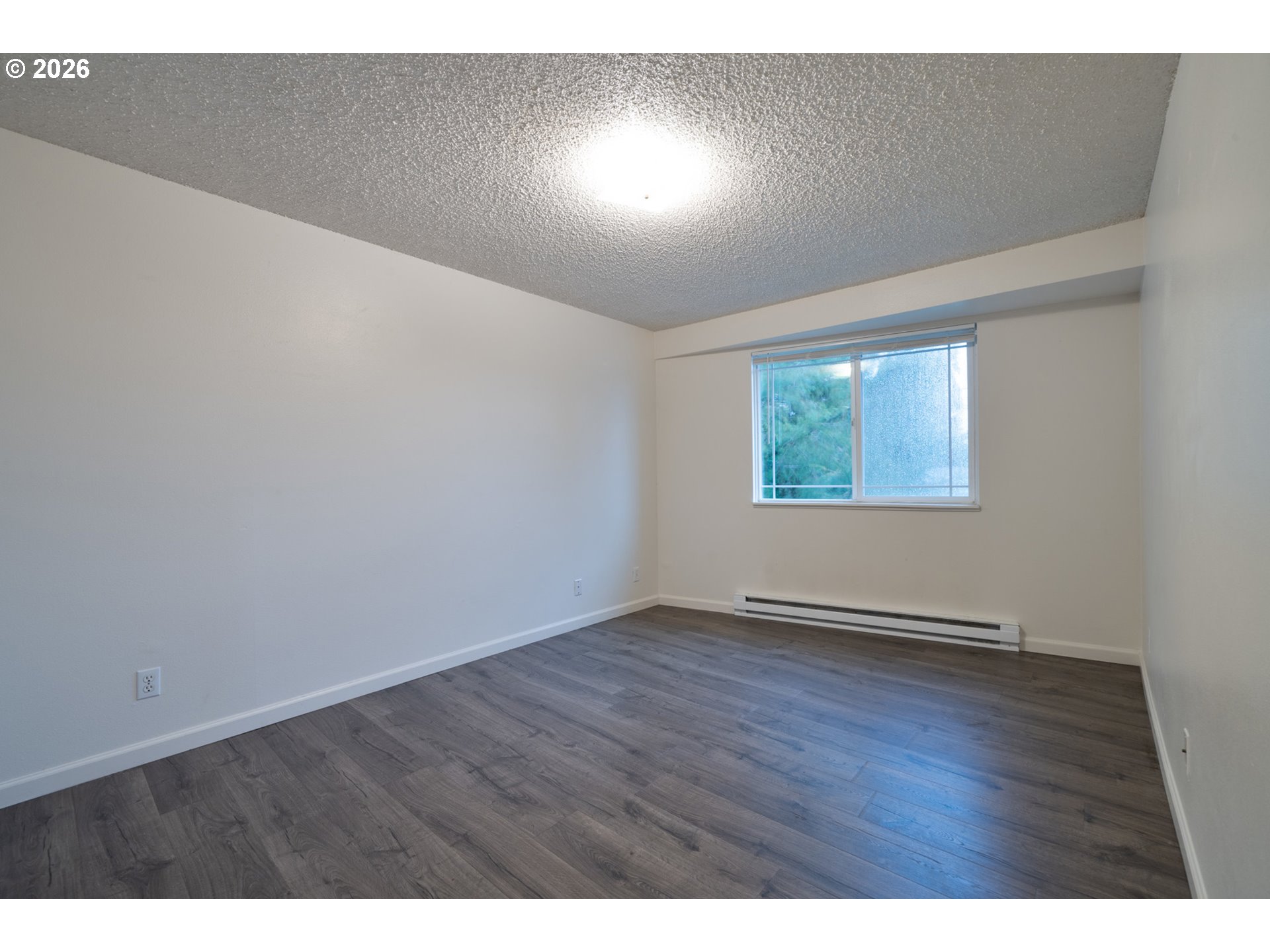 5514 3rd Street Tillamook, OR 97141 - Photo 14 of 25 an empty room with wooden floor and windows