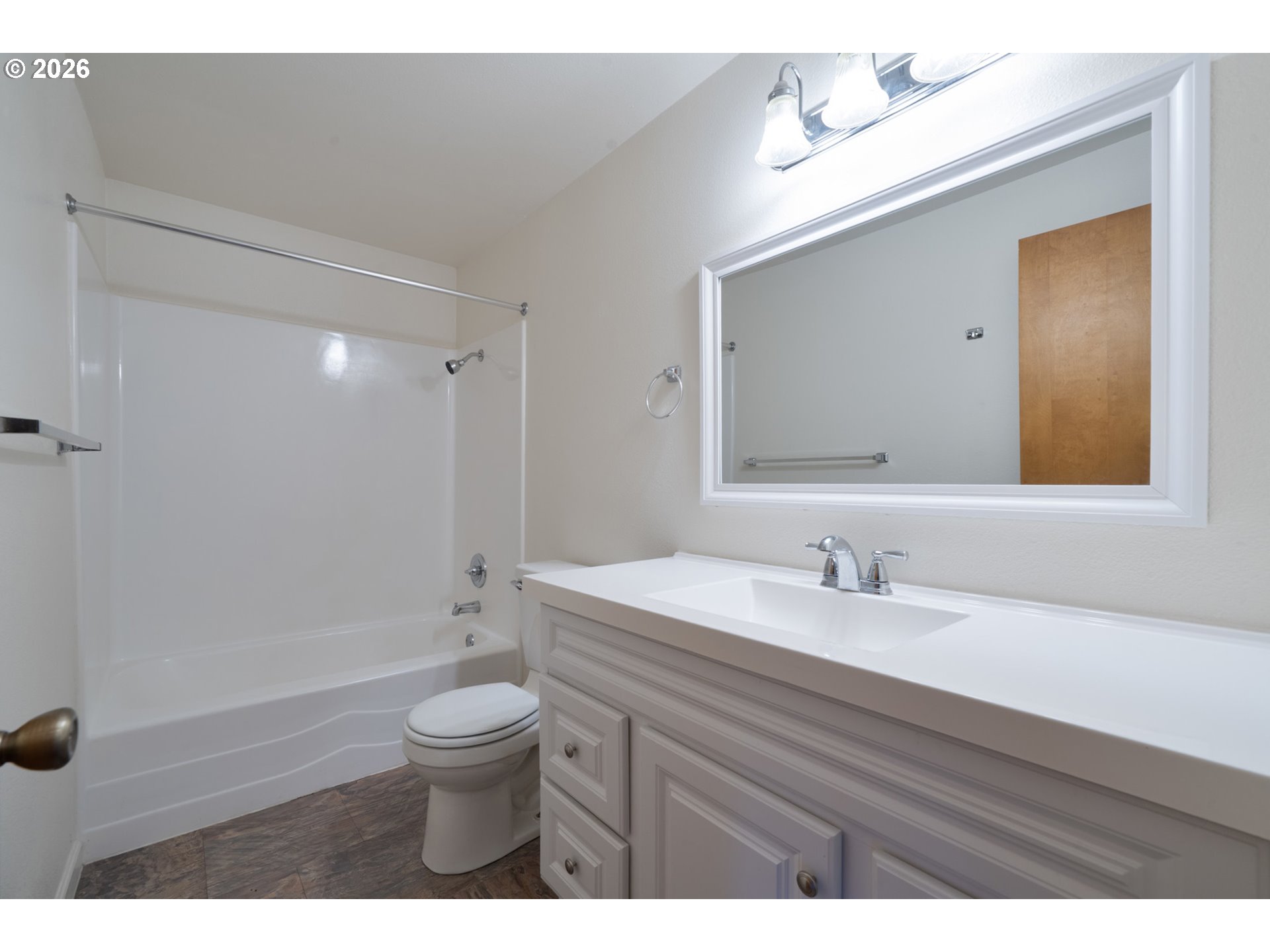5514 3rd Street Tillamook, OR 97141 - Photo 15 of 25 a bathroom with a toilet a sink a mirror and a shower