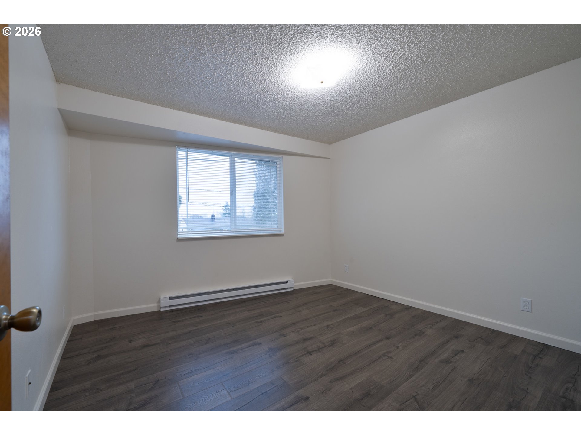 5514 3rd Street Tillamook, OR 97141 - Photo 18 of 25 an empty room with wooden floor and windows