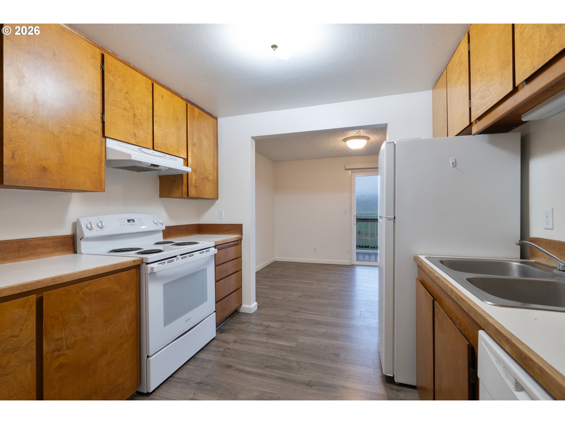 5514 3rd Street Tillamook, OR 97141 - Photo 7 of 25 a kitchen with stainless steel appliances granite countertop a sink stove and refrigerator