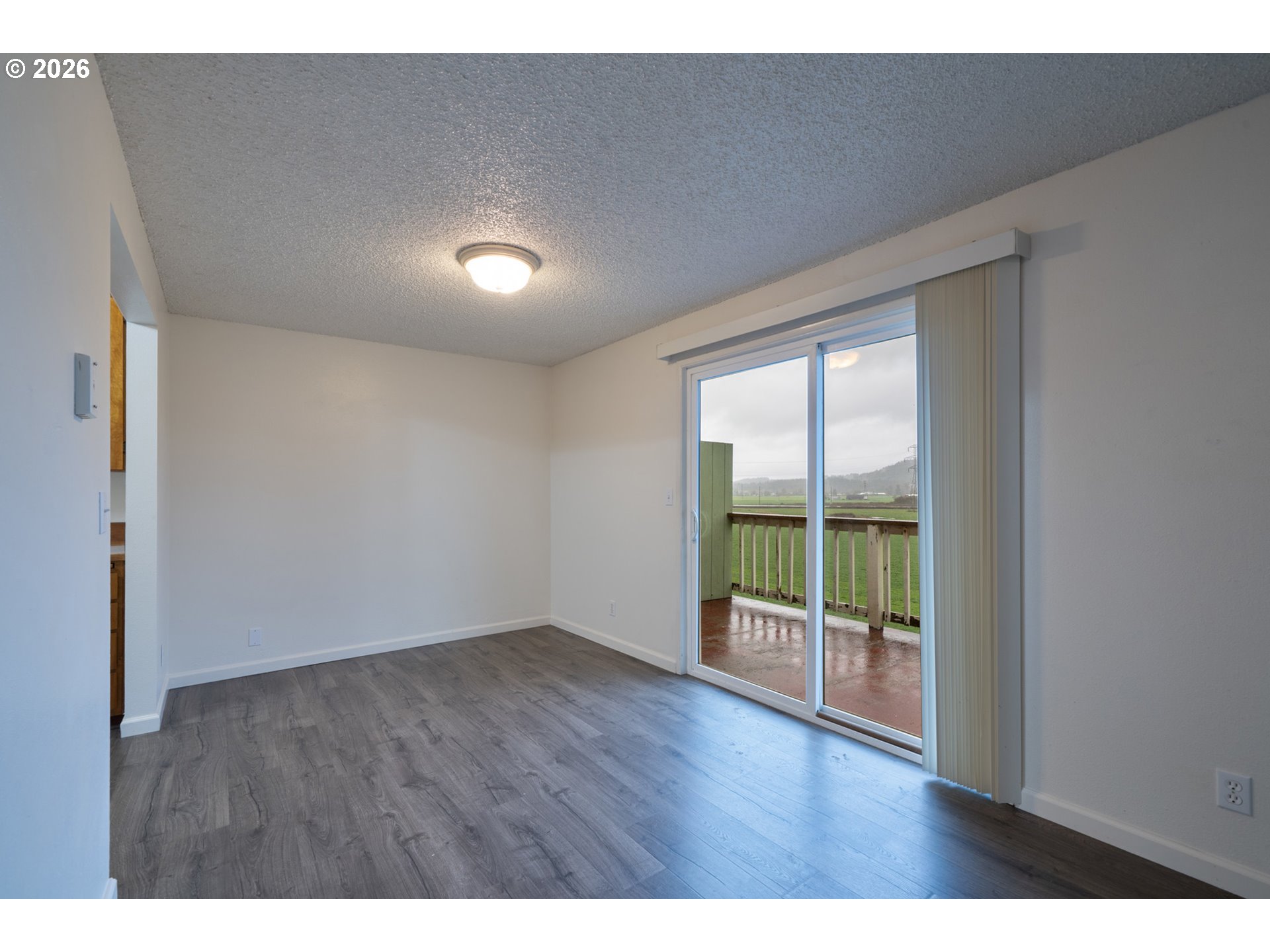 5514 3rd Street Tillamook, OR 97141 - Photo 9 of 25 a view of an empty room with wooden floor and a window