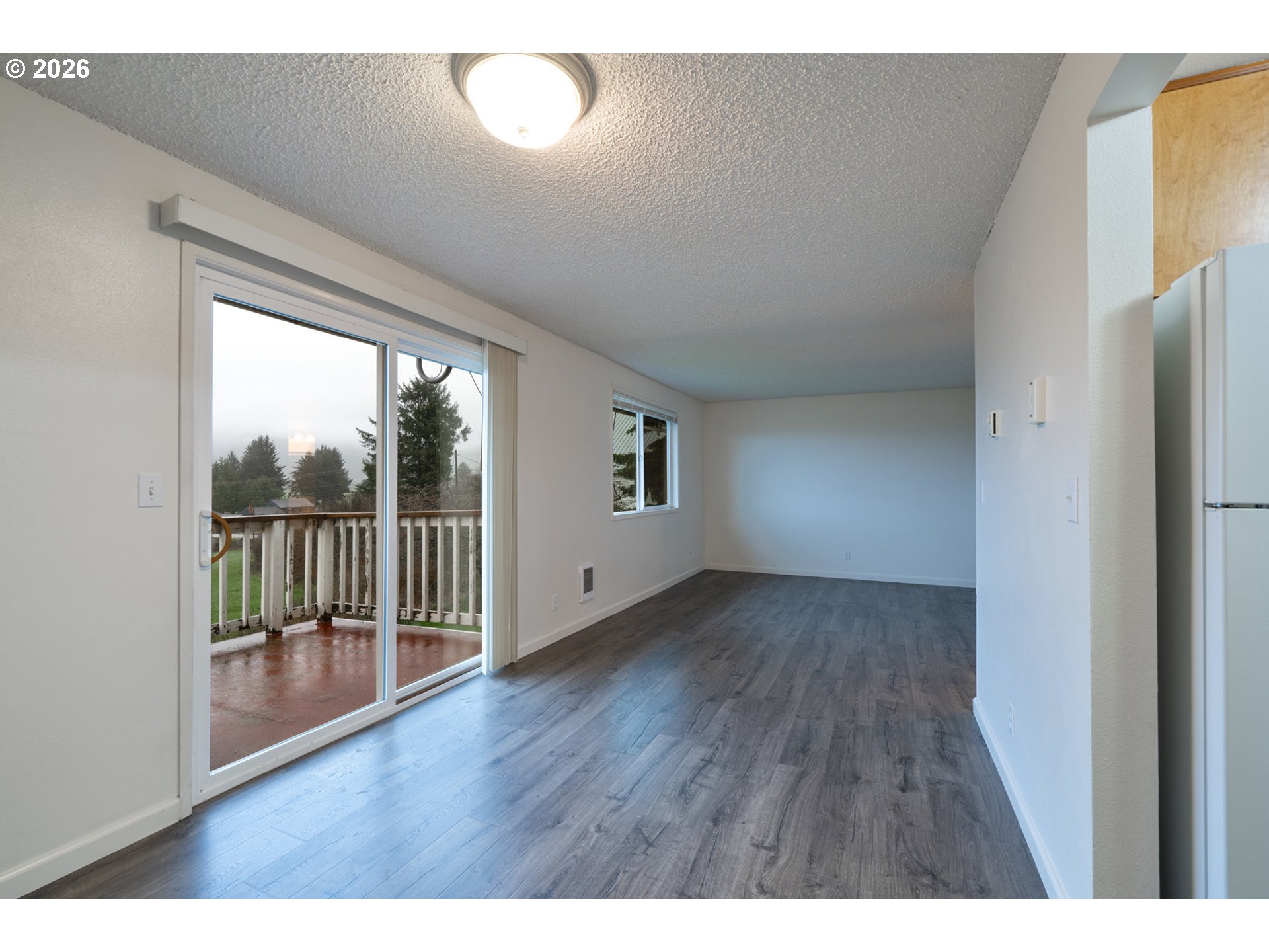 5514 3rd Street Tillamook, OR 97141 - Photo 10 of 25 a view of a room with wooden floor and a window