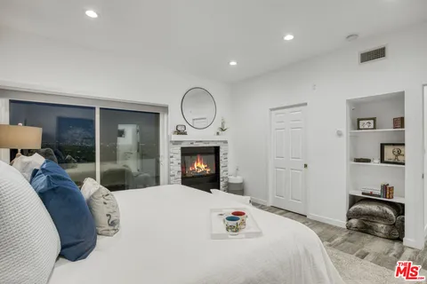a bedroom with a bed and a fireplace