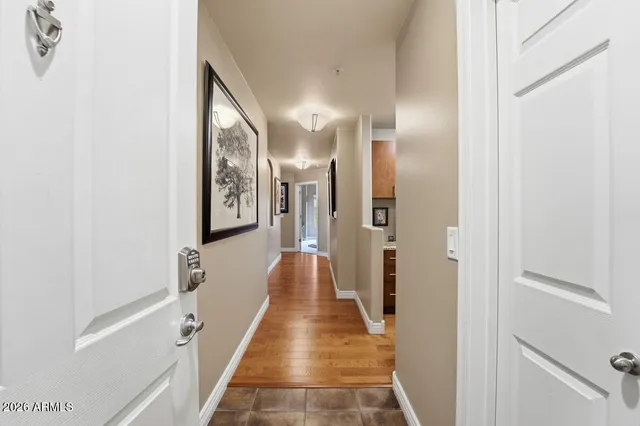 a view of a hallway with wooden floor