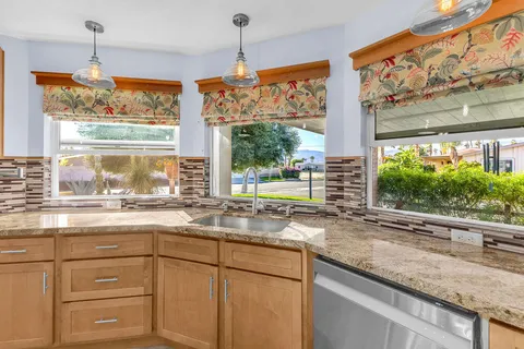 an aerial view of residential houses with outdoor space and river