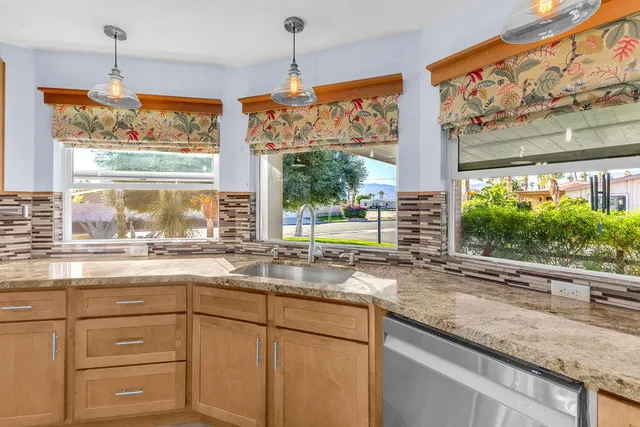 an aerial view of residential houses with outdoor space and river