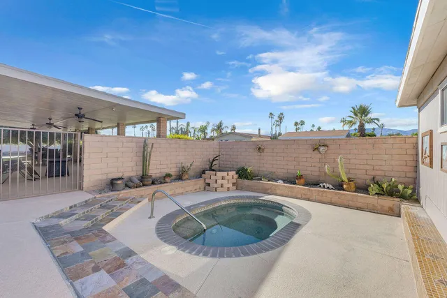 a kitchen with stainless steel appliances granite countertop a refrigerator a sink dishwasher a stove and a refrigerator