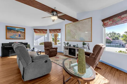 a kitchen with stainless steel appliances granite countertop white cabinets and a large window