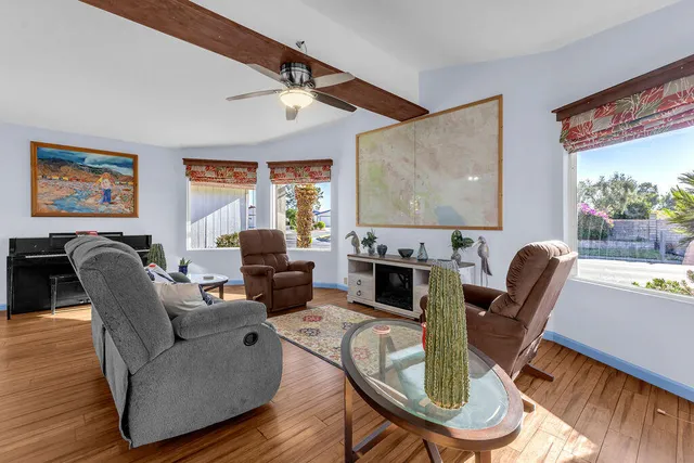a kitchen with stainless steel appliances granite countertop white cabinets and a large window