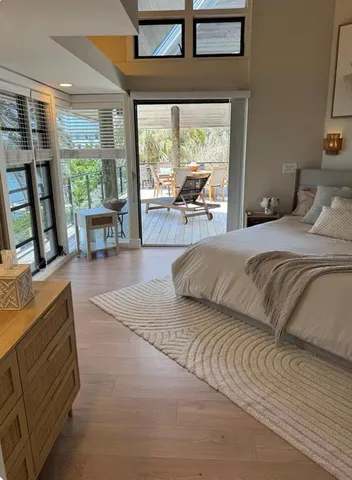 a bedroom with a large bed and a large window