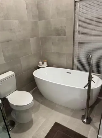 a white bath tub sitting next to a white toilet