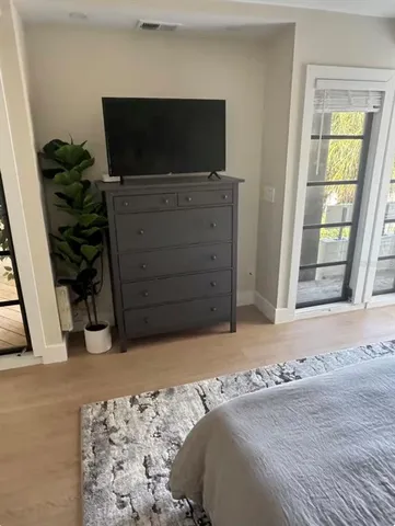 a bedroom with a bed and a television