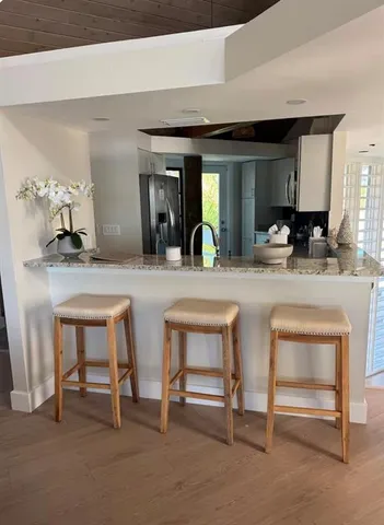 a view of hall way with furniture and chandelier