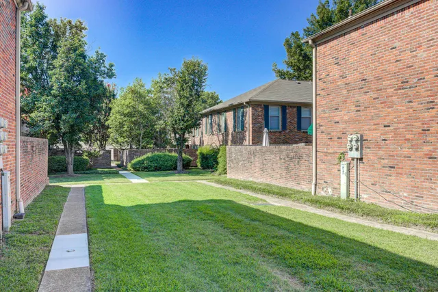 a view of a house with a yard and a garden