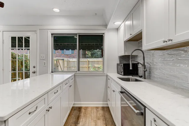 a kitchen that has a sink and a stove