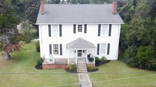 a front view of a house with garden