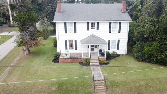 202 Veazey Street Union Point, GA 30669 - Photo 2 of 57 a front view of a house with a garden