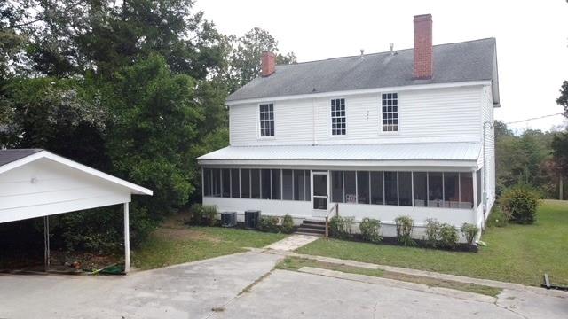 202 Veazey Street Union Point, GA 30669 - Photo 53 of 57 a view of a white house with a yard and large tree
