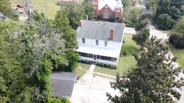 202 Veazey Street Union Point, GA 30669 - Photo 54 of 57 an aerial view of a house with swimming pool and garden