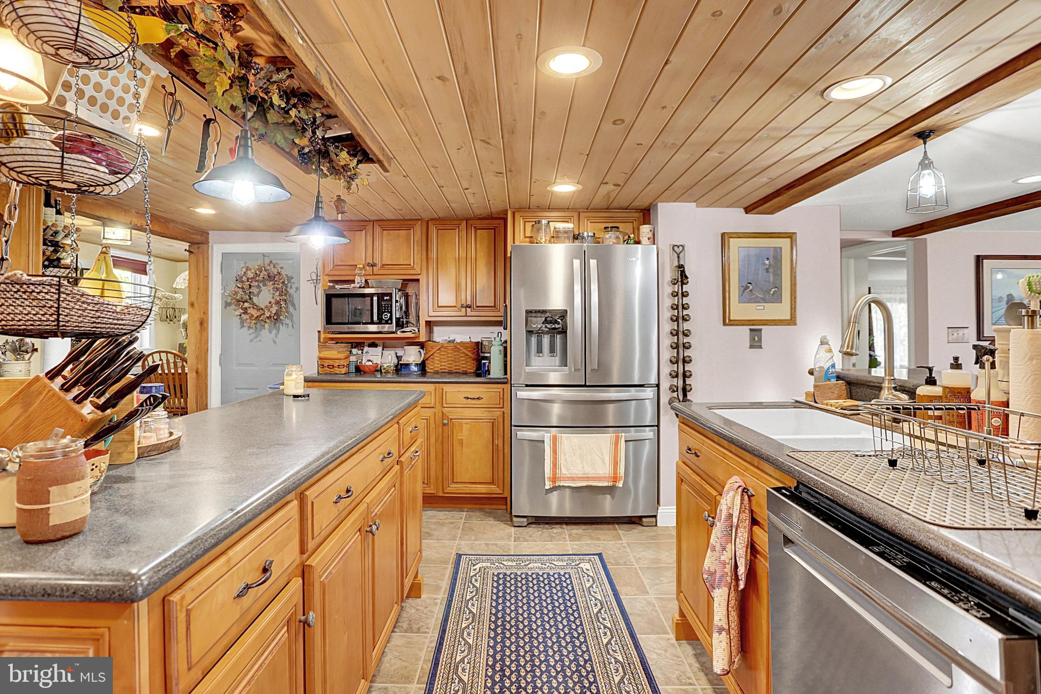 64 Metz Road Thompsontown, PA 17094 - Photo 17 of 59 a kitchen with stainless steel appliances granite countertop a sink a stove and a refrigerator