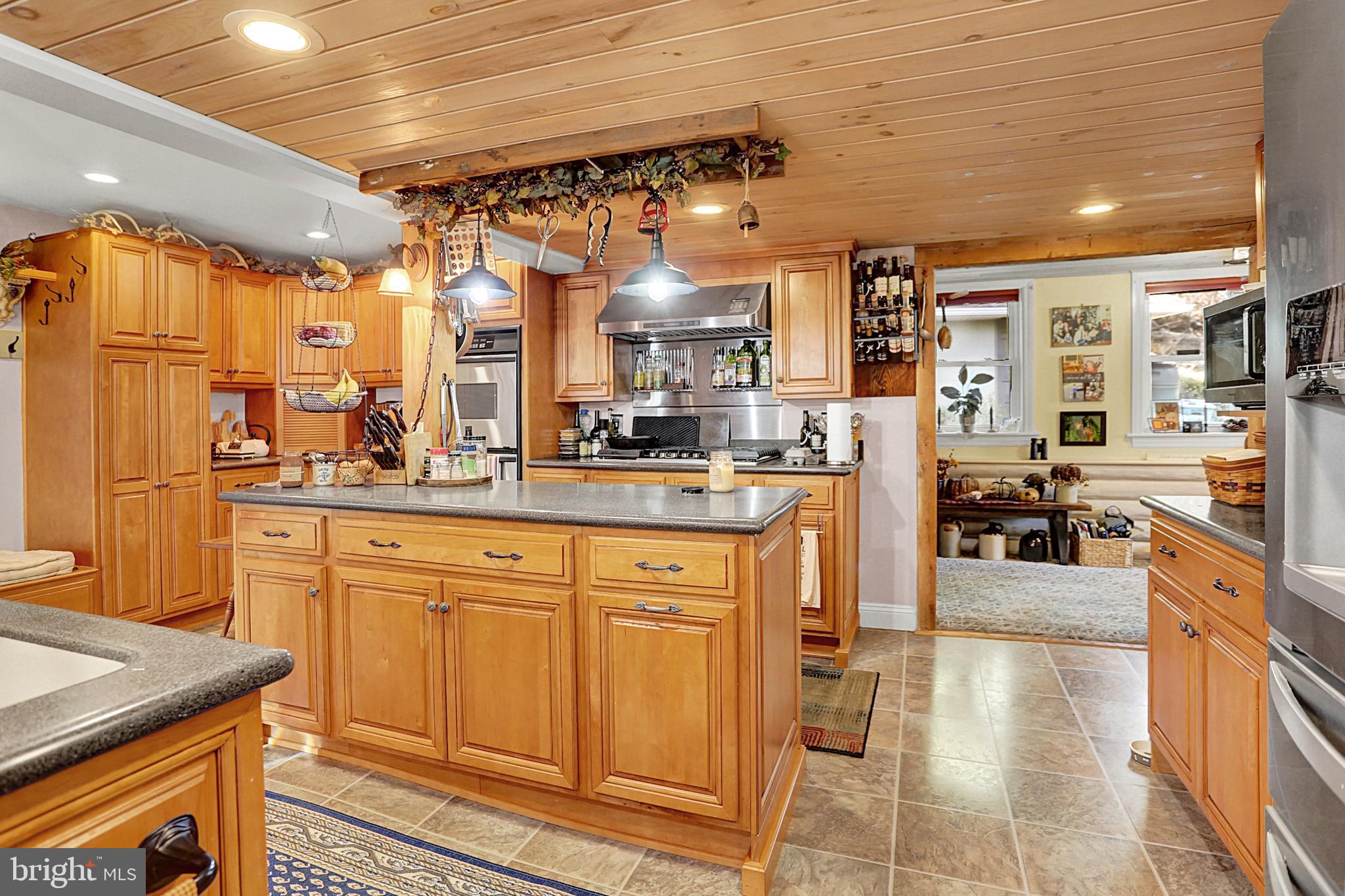 64 Metz Road Thompsontown, PA 17094 - Photo 18 of 59 a kitchen with stainless steel appliances granite countertop a refrigerator a oven and white cabinets with wooden floors
